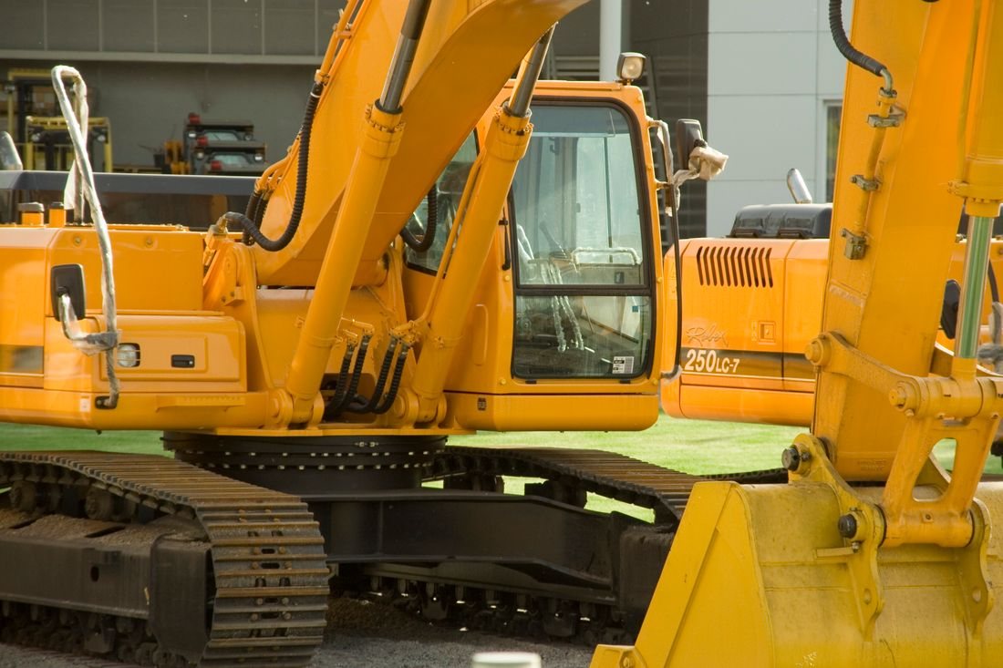 Factory-new excavators with protective wrapping still on